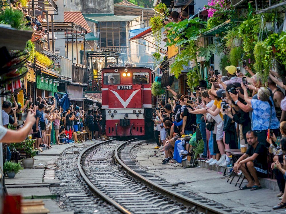 Locals sip coffee just steps away from the railway tracks 
